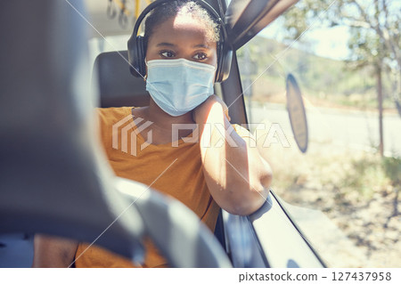 Black woman, covid or headphones in bus, public transport or commute in healthcare, bacteria virus or wellness compliance. Thinking, travel passenger or student face mask and listening to radio music 127437958