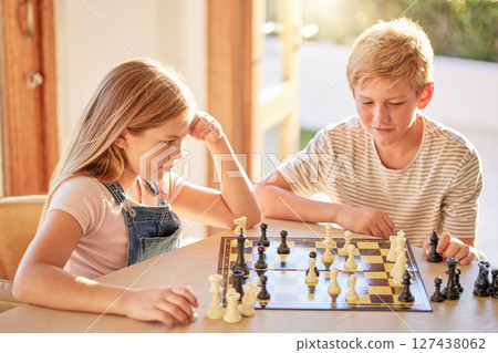 Children, chess and board game while thinking of move with knowledge, strategy and planning to win for development and growth at home. Kids, siblings or boy and girl together for learning games Children, chess and board game while thinking of move with knowledge, strategy and planning to win for development and growth at home. Kids, siblings or boy and girl together for learning games 127438062