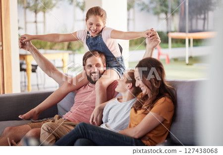 Happy family, smile and love, playing and sofa for quality bonding or relaxing together at home. Mother, father and children smiling for joy in playful fun and family time on the living room couch 127438068