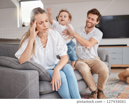 Family, stress and headache of mother on sofa with father, hyper active energy and adhd child. Tired, burnout and woman in living room with boy and dad feeling depression or anxiety in home with kid. 127438081