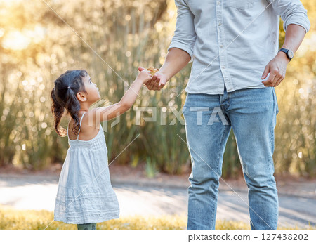 Leaf, autumn and girl with her father in a park with love, relax and quality time together. Nature, care and child giving leaves to her dad during a walk for adventure, peace and calm as family 127438202