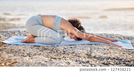 Beach yoga, fitness and woman stretching down, kneeling and balance, childs pose and health. Balasana exercise, mindfulness and sea workout, energy and wellness, zen and pilates, nature or meditation 127438221