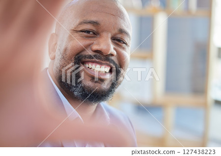 Black man, happy and selfie with a businessman taking a picture while standing alone in the office at work. Portrait, happy and smile with a male employee for a social media photograph while working Black man, happy and selfie with a businessman taking a picture while standing alone in the office at work. Portrait, happy and smile with a male employee for a social media photograph while working 127438223