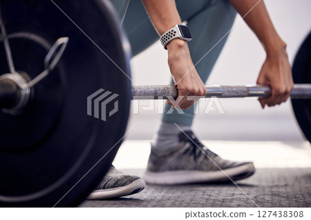 Fitness, exercise and strong, woman with barbell doing deadlift during workout and weight training for a healthy body. Sports model with a watch and weights for motivation, health and wellness 127438308