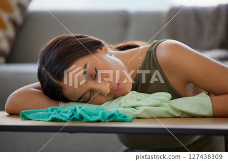 Cleaner, relax and sleep on table in home after cleaning with cloth and rubber gloves. Spring cleaning, burnout and tired woman house worker sleeping, nap or resting after complete household tasks. 127438309