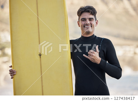 Happy surfer, hand sign and man, portrait and motivation, beach and summer sports, freedom and happiness in sunshine. Surfing board, shaka and smile guy, ocean and relax, adventure and Miami vacation 127438417