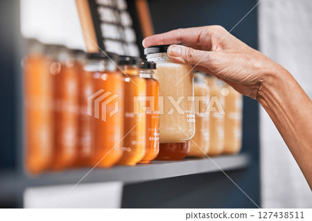 Hands, jar and honey shelf for inventory check, product pricing or labeling in organic retail store. Hand in small business, management or market advertising of healthy glass food products for sale Hands, jar and honey shelf for inventory check, product pricing or labeling in organic retail store. Hand in small business, management or market advertising of healthy glass food products for sale 127438511