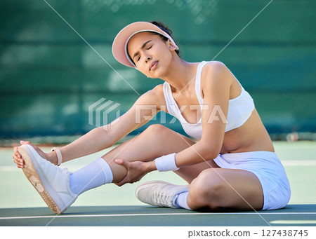 Tennis court, sport injury and foot pain with athlete woman on ground for sprain, rheumatism or neuropathy after fitness training. Sports model with arthritis, fibromyalgia or osteoporosis problem 127438745