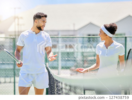 Tennis, sports and fitness with a man and woman playing a game on a tennis court for competition. Workout, motivation and training with a male and female tennis player talking after a match point Tennis, sports and fitness with a man and woman playing a game on a tennis court for competition. Workout, motivation and training with a male and female tennis player talking after a match point 127438759