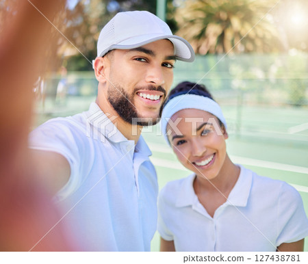Selfie, tennis and sports with a couple on a court to take a photograph after their training or game. Portrait, fitness and sport with a man and woman tennis player posing for a picture together Selfie, tennis and sports with a couple on a court to take a photograph after their training or game. Portrait, fitness and sport with a man and woman tennis player posing for a picture together 127438781