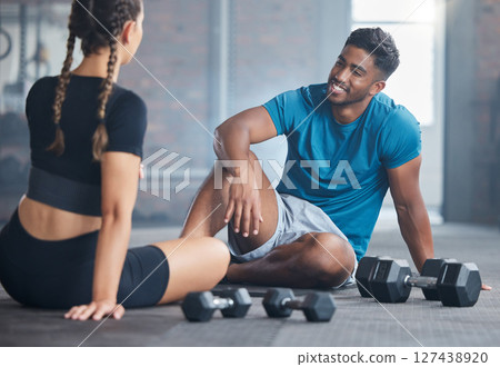 Happy couple, fitness and exercise with personal trainer and client talking about wellness, health and workout plan on gym floor. Happy indian man and woman together for training and motivation 127438920