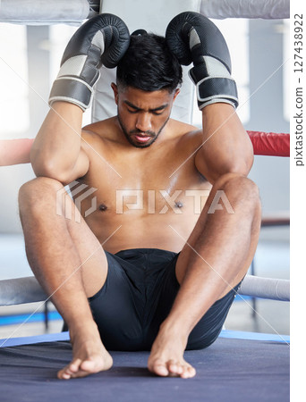 Tired man, boxer and fitness in sports match for ring out finish, training or competitive workout at the gym. Exhausted or fatigue man fighter in boxing arena on break from intense fighting exercise Tired man, boxer and fitness in sports match for ring out finish, training or competitive workout at the gym. Exhausted or fatigue man fighter in boxing arena on break from intense fighting exercise 127438922