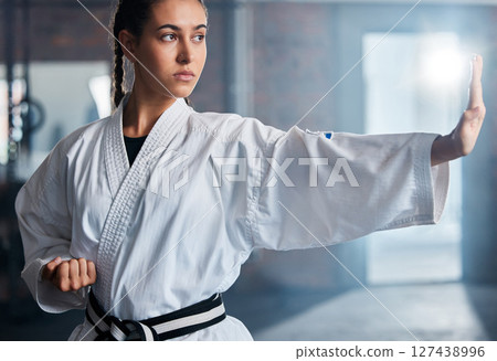 Karate, fitness and sport with woman, workout and training for fight, fitness and exercise in gym. Female athlete and champion attitude for self defense, training and power exercise with motivation 127438996