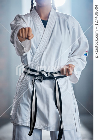 Karate punch, martial arts and body of woman, battle warrior or fighter in training practice, fitness workout or fight challenge. Action, fist power and girl learning self defense for safety security Karate punch, martial arts and body of woman, battle warrior or fighter in training practice, fitness workout or fight challenge. Action, fist power and girl learning self defense for safety security 127439004