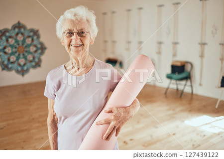 Yoga, mat and portrait of a senior woman in a wellness studio for an exercise or meditation class. Happy, smile and elderly female in retirement at mind and body pilates workout for peace and balance Yoga, mat and portrait of a senior woman in a wellness studio for an exercise or meditation class. Happy, smile and elderly female in retirement at mind and body pilates workout for peace and balance 127439122