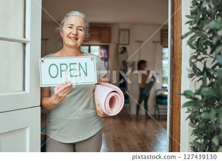 Woman, portrait and advertising open sign, yoga studio and fitness club, healthy lifestyle and senior wellness. Happy old woman at door of exercise, workout and training center with marketing signage Woman, portrait and advertising open sign, yoga studio and fitness club, healthy lifestyle and senior wellness. Happy old woman at door of exercise, workout and training center with marketing signage 127439130