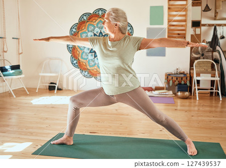 Senior yoga, training and woman pilates stretching of a elderly person feeling zen and relax. Spiritual balance exercise in a wellness studio for healthy lifestyle, meditation fitness and workout Senior yoga, training and woman pilates stretching of a elderly person feeling zen and relax. Spiritual balance exercise in a wellness studio for healthy lifestyle, meditation fitness and workout 127439537