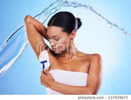 Black woman, water splash and shaving armpit with cream for skincare body health, cosmetics hygiene and beauty grooming routine. Self care, hair removal and epliation studio mockup on blue background Black woman, water splash and shaving armpit with cream for skincare body health, cosmetics hygiene and beauty grooming routine. Self care, hair removal and epliation studio mockup on blue background 127439673