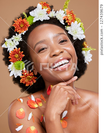 Black woman, skincare and flowers for natural beauty and skin glow wellness treatment. Portrait of a woman model smile happy about cosmetic plant, hair care and spring organic facial with happiness 127439679