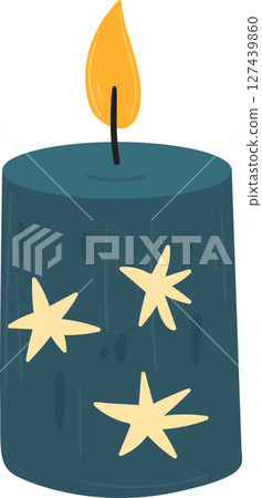 A festive blue candle with bright yellow stars glows in the dark. 127439860