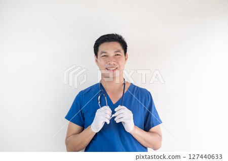 Smiling Asian Male Nurse in Scrubs with Gloves and Stethoscope 127440633
