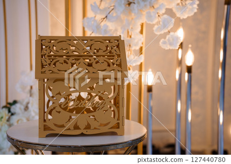 Elegant Wooden Wedding Card Box with Floral Accents and Gold Decor: Rustic Reception Centerpiece for a Romantic Celebration. Elegant Wooden Wedding Card Box with Floral Accents and Gold Decor: Rustic Reception Centerpiece for a Romantic Celebration. 127440780