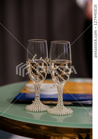 Elegant Champagne Flutes with Pearl Accents at Wedding Celebration: Close-Up of Toasts, Sparkling Wine, Dark Background, Luxury Detail Elegant Champagne Flutes with Pearl Accents at Wedding Celebration: Close-Up of Toasts, Sparkling Wine, Dark Background, Luxury Detail 127440816