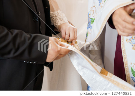 Orthodox Jewish Wedding Ceremony Exchange of Rings and Blessing by Rabbi in Traditional Attire, Light Cream and Gold Tones 127440821