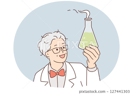 Laboratory assistant holds flask with green fuming liquid while examining chemical reaction 127441303