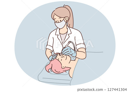 Woman cosmetologist performs microdermabrasion or mechanical peeling and diamond face polishing Woman cosmetologist performs microdermabrasion or mechanical peeling and diamond face polishing 127441304