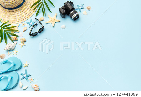 Summer accessories creating frame on light blue background with copy space 127441369