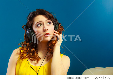 girl in big headphones listening music mp3 relaxing 127441509