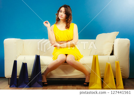 Woman with shopping bags on couch Woman with shopping bags on couch 127441561
