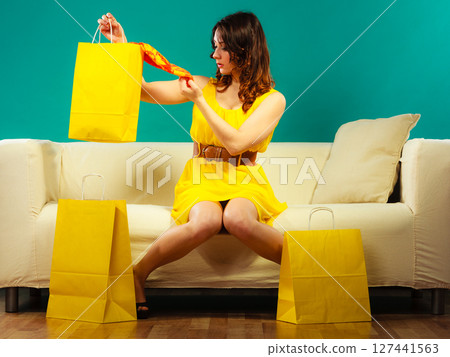 Woman with shopping bags on couch Woman with shopping bags on couch 127441563