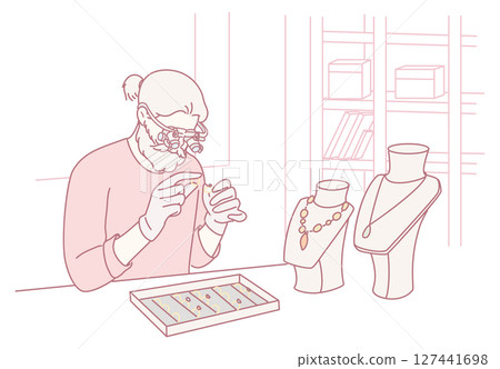 A skilled jeweler meticulously working on the intricate details of fine jewelry pieces 127441698