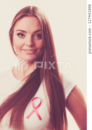 Woman wih pink cancer ribbon on chest Woman wih pink cancer ribbon on chest 127441806