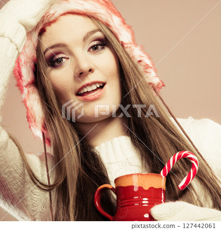 Christmas girl with mug and cane. Christmas girl with mug and cane. 127442061