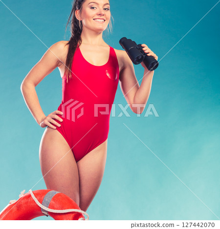 Lifeguard woman on duty with ring buoy lifebuoy. 127442070