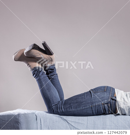 woman legs in denim trousers high heels shoes 127442079