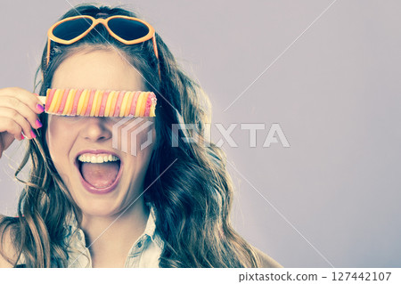Summer woman eating popsicle ice pop cream Summer woman eating popsicle ice pop cream 127442107