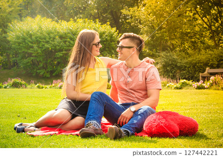 Couple with big heart on picnic Couple with big heart on picnic 127442221