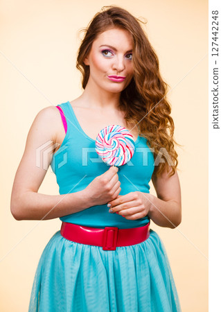Woman joyful girl with lollipop candy Woman joyful girl with lollipop candy 127442248