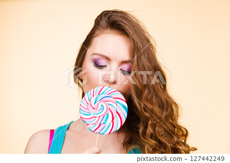 Woman joyful girl with lollipop candy Woman joyful girl with lollipop candy 127442249