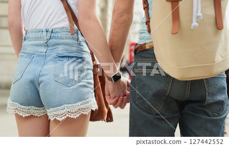 Love, city travel and couple holding hands on student gap year vacation while walking in Madrid Spain. Urban street road, bond or city back view of casual man and woman tour Europe on holiday journey Love, city travel and couple holding hands on student gap year vacation while walking in Madrid Spain. Urban street road, bond or city back view of casual man and woman tour Europe on holiday journey 127442552