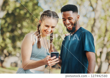 Phone, music and fitness with a diversity couple streaming audio while running in the park for exercise. Nature, social media and workout with a sports man and woman listening to the radio together Phone, music and fitness with a diversity couple streaming audio while running in the park for exercise. Nature, social media and workout with a sports man and woman listening to the radio together 127442580