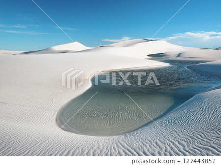 Under the blue sky, water springs from the white desert. An image of dryness and moisture. 127443052