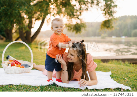 Mother Lying On Grass With Toddler Mother Lying On Grass With Toddler 127443331