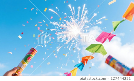 Popping crackers into the blue sky at a party 127444231