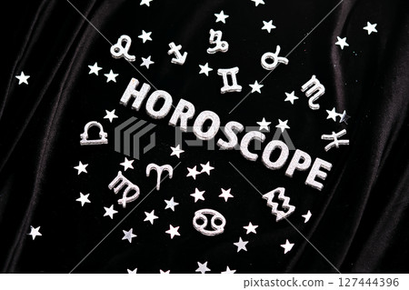 Horoscope inscription on a black velvet background. 127444396