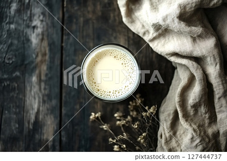 Glass of plant based milk on rustic wooden table with linen cloth 127444737